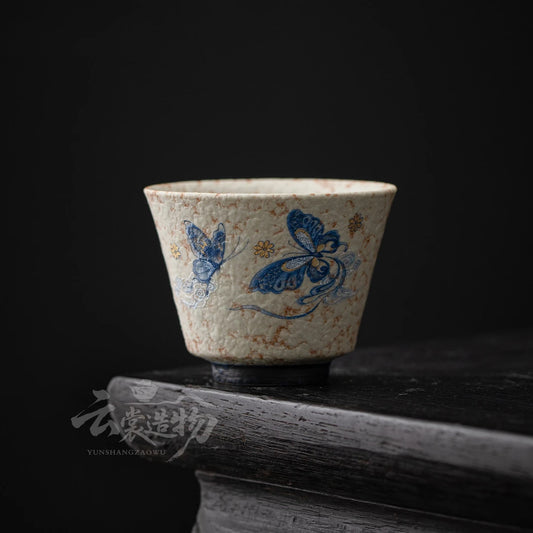 Blue butterfly ceramic gongfu tea cup on a dark table